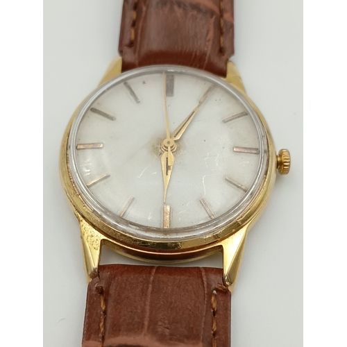 479 - A 9ct gold tudor manual wind wrist watch. Working. Dennison case. stamped rolex. Apx 10g gold.