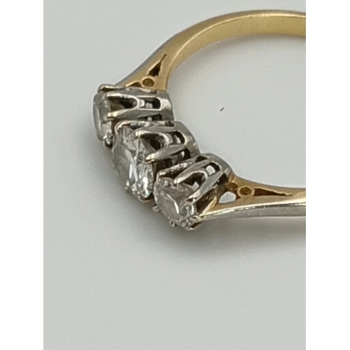 506 - A stamped 18ct & platinum diamond trilogy ring. 2.2grams. .75 carat diamonds. Size M -.