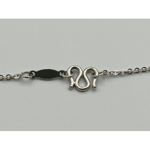 499 - A stamped 950 platinum necklace set with a 1.9ct opal, topaz and diamonds. Length 17 inches