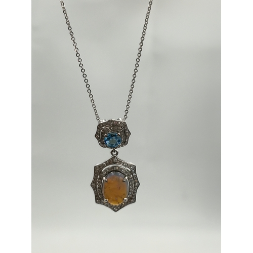 499 - A stamped 950 platinum necklace set with a 1.9ct opal, topaz and diamonds. Length 17 inches