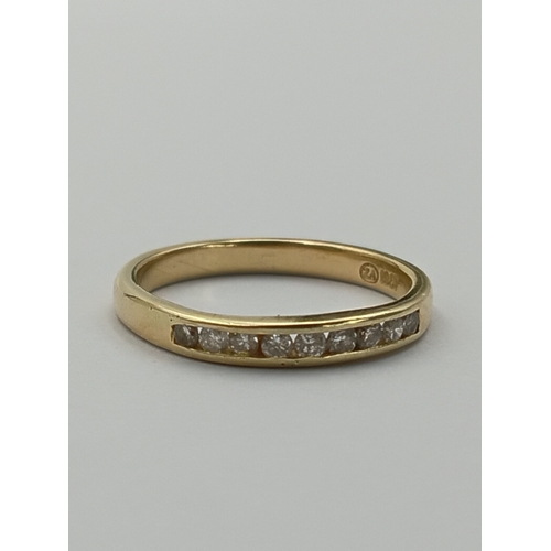 503 - A stamped 18ct gold half eternity ring set with 9 diamonds. Total weight 3g