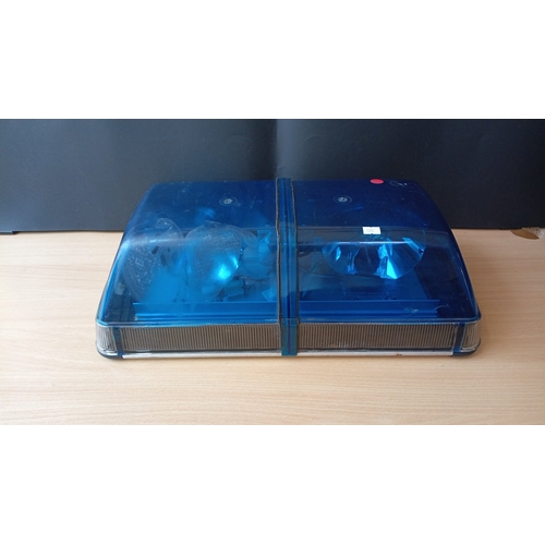 Automotive emergency roof light bar with twin blue polycarbonate lenses over a ribbed clear band, enclosing reflector assemblies; the reverse with an aluminium mounting plate and wiring leads, unmarked.