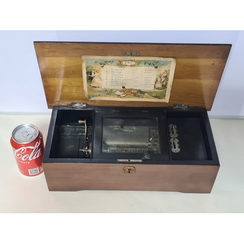 An antique 19th Century Swiss Cylinder Music Box. House in a lockable wooden box. Key is missing. In working order with hand crank mechanism working. Plays really well.
Box measures 38cm x19cm x12cm.