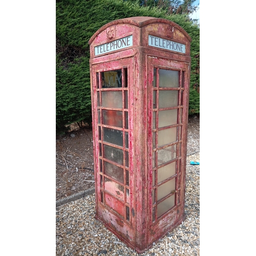 Cast-iron British K6 model telephone box, with domed roof, crown crest panels, glazed window-lights, and “TELEPHONE” fascia; retaining remnants of red paint and a “PULL” door plate. Includes working pay telephone as shown. In need of some attention - Buyer to dismantle and collect from Birmingham.