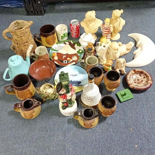 A group of decorative ceramics and figures, including stoneware mugs ...