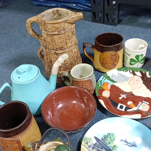 A group of decorative ceramics and figures, including stoneware mugs ...