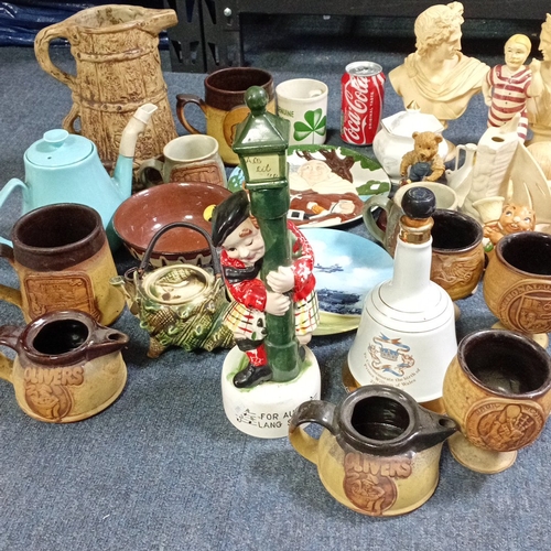 A group of decorative ceramics and figures, including stoneware mugs ...