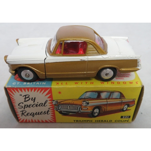 222 - Corgi. Triumph Herald Coupe No. 231, excellent in excellent box, two-tone white and gold, red interi... 