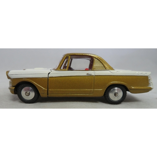 222 - Corgi. Triumph Herald Coupe No. 231, excellent in excellent box, two-tone white and gold, red interi... 