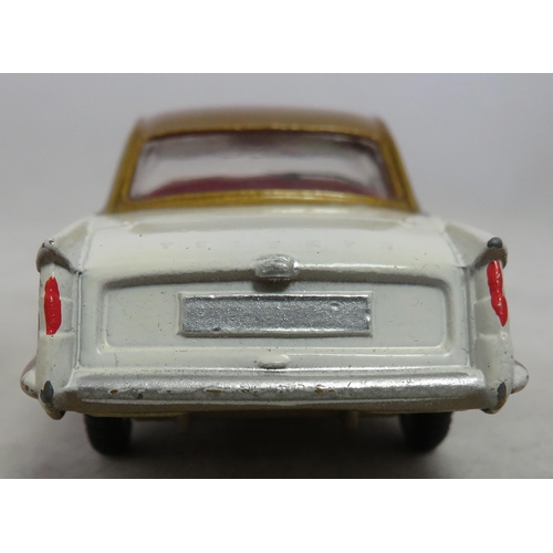 222 - Corgi. Triumph Herald Coupe No. 231, excellent in excellent box, two-tone white and gold, red interi... 