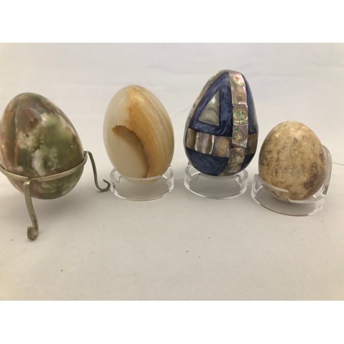 230 - Selection of assorted paperweights and mineral eggs plus stands.