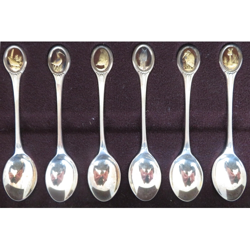 195 - The RSPB Silver Spoon Collection - a set of twelve silver and silver-gilt teaspoons, each set with o... 