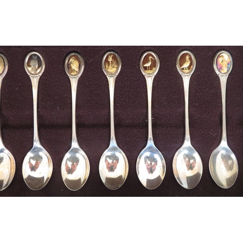 195 - The RSPB Silver Spoon Collection - a set of twelve silver and silver-gilt teaspoons, each set with o... 