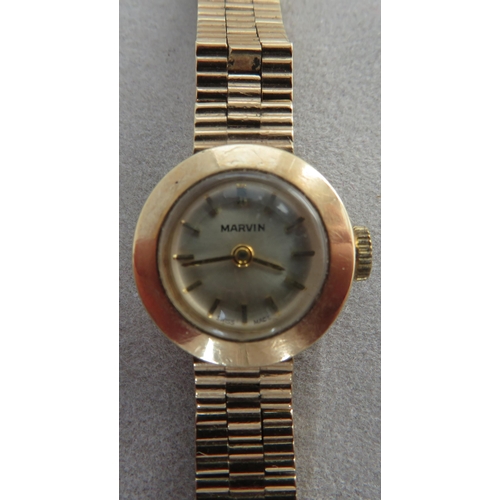 157 - Watch - A Swiss made 9ct gold Marvin ladies watch on a 9ct gold bracelet. Stamped N&TLtd and fully h... 