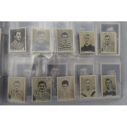 60 - Football cigarette and trade cards in an album, part sets and odds, in mixed condition, with Gallahe... 