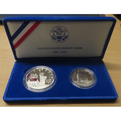 319 - 1986 Liberty silver dollar and (CuNi) half dollar cased set with COA.