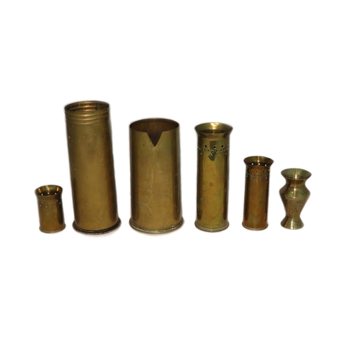 77 - Trench Art. Range of six vases made from shells, ranging from 7.5cm tall to 23 cm tall.