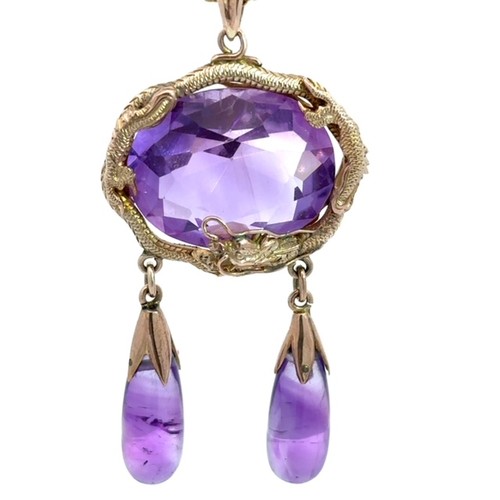 54 - Unusual amethyst pendant with large oval cut amethyst (20mm x 18mm approx) encircled by gold dragon ... 