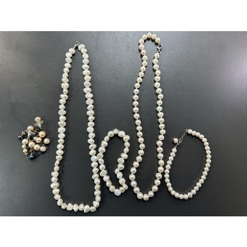 51 - Two cultured pearl necklaces with matching bracelets. Also several pairs of cultured pearl earrings.