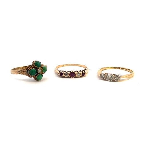 28 - 3 gem set gold rings. A three stone diamond ring, size k, set in unmarked gold (tests as between 18c... 