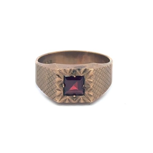 11 - 9ct rose gold ring in signet style, set with an almandine garnet. Total weight 5.37g approx. Size T.