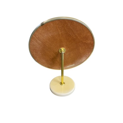 183 - A pair of 1970’s retro style Schreiber circular dressing table mirrors, with the adjustable plate on... 