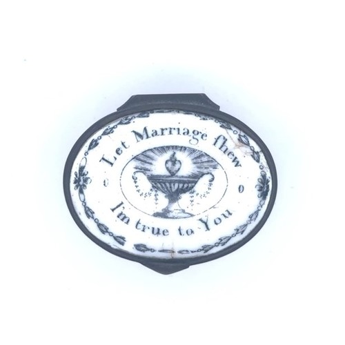 57 - A Bilston oval enamel patch box with a pink fluted base and a hinged monochrome lid with the motto '... 