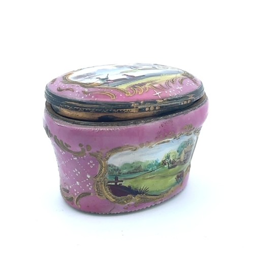 61 - An enamel hand painted pink enamel patch box, probably Bilston with a hinged lid (some damage to met... 