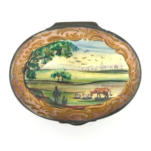 62 - A Battersea/ Bilston hand painted enamel patch box with hinged lid depicting a rural scene and a flo... 