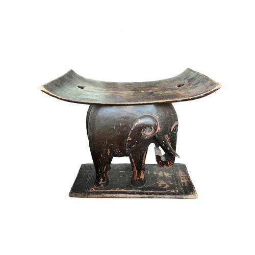 70 - An African carved wooden African tribal stool/seat with carved elephant holding the concave seat alo... 