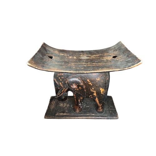 70 - An African carved wooden African tribal stool/seat with carved elephant holding the concave seat alo... 