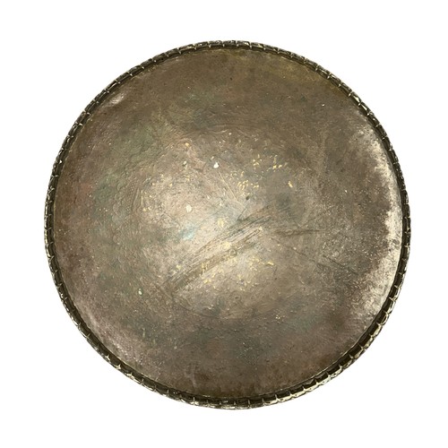 99 - A large pressed brass Celtic style charger. Diameter 67cm.