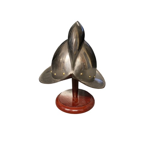 151 - A reproduction Morion helmet (Spanish) on stand. Steel with brass stud detailing.