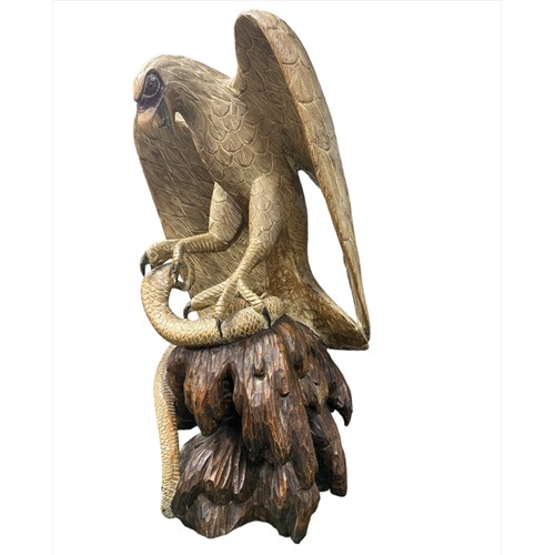 216 - Very large wooden sculpture of an eagle attacking/catching a cobra with its talons – open beaked ton... 