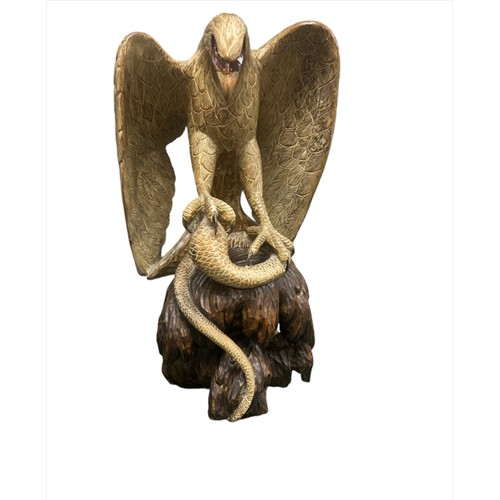 216 - Very large wooden sculpture of an eagle attacking/catching a cobra with its talons – open beaked ton... 