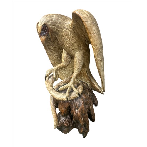 216 - Very large wooden sculpture of an eagle attacking/catching a cobra with its talons – open beaked ton... 