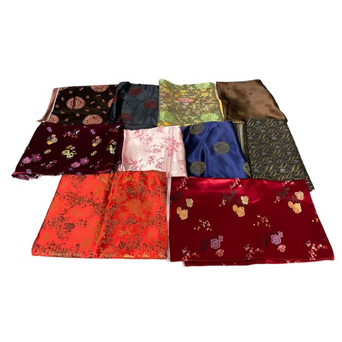 80 - A large selection of Chinese silk material, various sizes, colours and patterns, predominantly orien... 