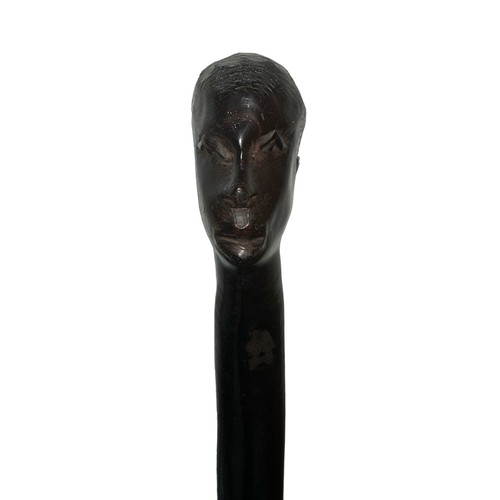 280 - An African carved hardwood twisted walking stick with carved head top. Height 83cm.