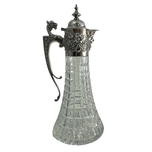 204 - A 1970 silver and cut glass claret jug. Elaborate silver mount with mask head handle, Bacchanalian m... 