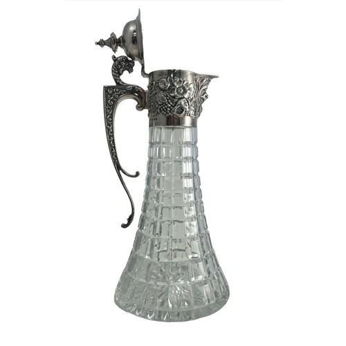 204 - A 1970 silver and cut glass claret jug. Elaborate silver mount with mask head handle, Bacchanalian m... 