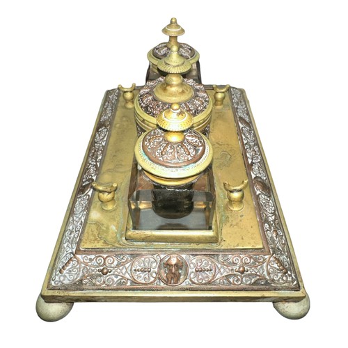 424 - A brass decorative desk tidy with three inkwells, two glass (one damaged). With decorative dragonfly... 