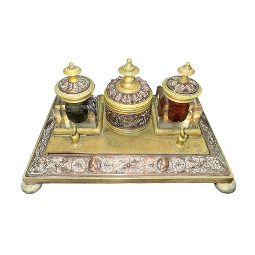 424 - A brass decorative desk tidy with three inkwells, two glass (one damaged). With decorative dragonfly... 