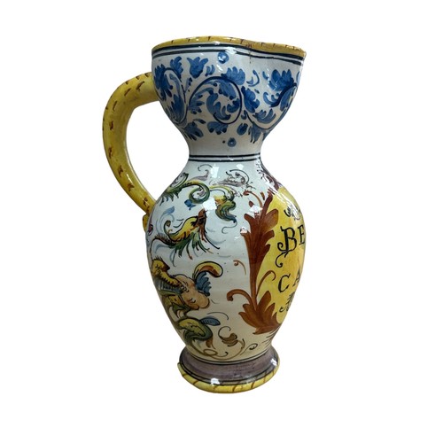 362 - An Italian maiolica (tin glazed) apothecary jug.  Decoration surrounds central reserve on which is w... 