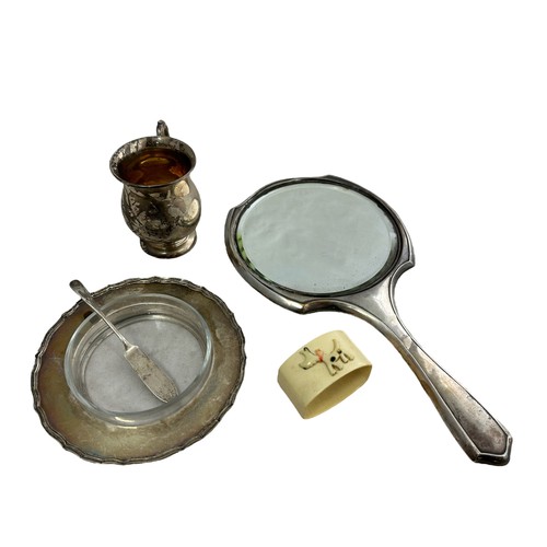 378 - A silver handheld dressing mirror, a silver tankard, a butter dish with separate glass interior and ... 