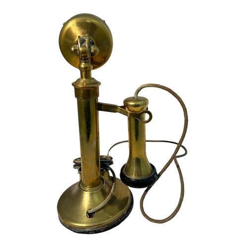 284 - A 20th century vintage brass and candlestick telephone with chrome metal dial. Measures 32cm tall.