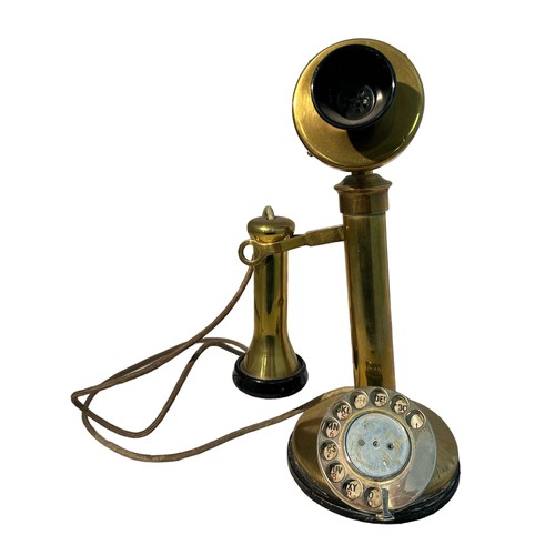 284 - A 20th century vintage brass and candlestick telephone with chrome metal dial. Measures 32cm tall.