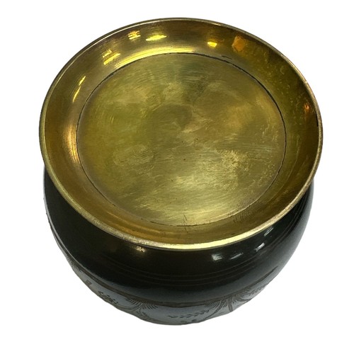 139 - A black painted brass cigarette dispenser / ashtray with floral and bird design carved into the exte... 