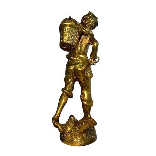 403 - A polished brass sculpture of a walking boy with a bindle. Height 34cm.