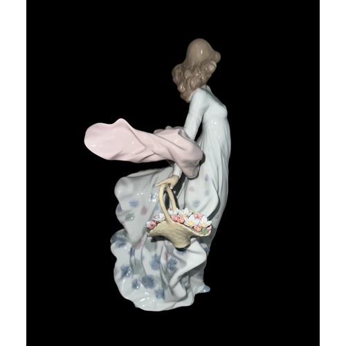 334 - A large Lladro ‘Spring Splendor’ ceramic figurine of a lady holding a floral basket in a flowing dre... 