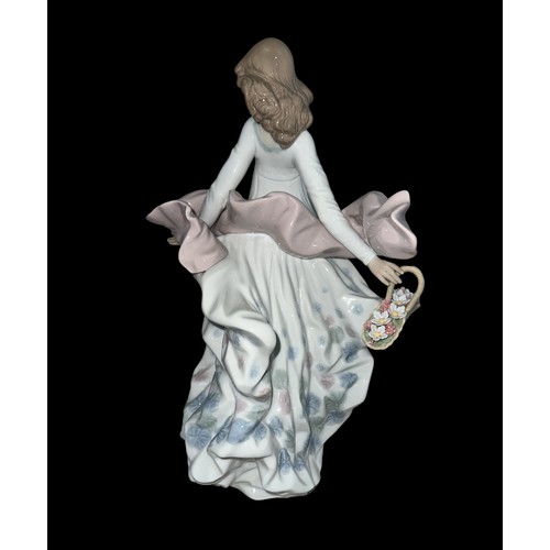 334 - A large Lladro ‘Spring Splendor’ ceramic figurine of a lady holding a floral basket in a flowing dre... 